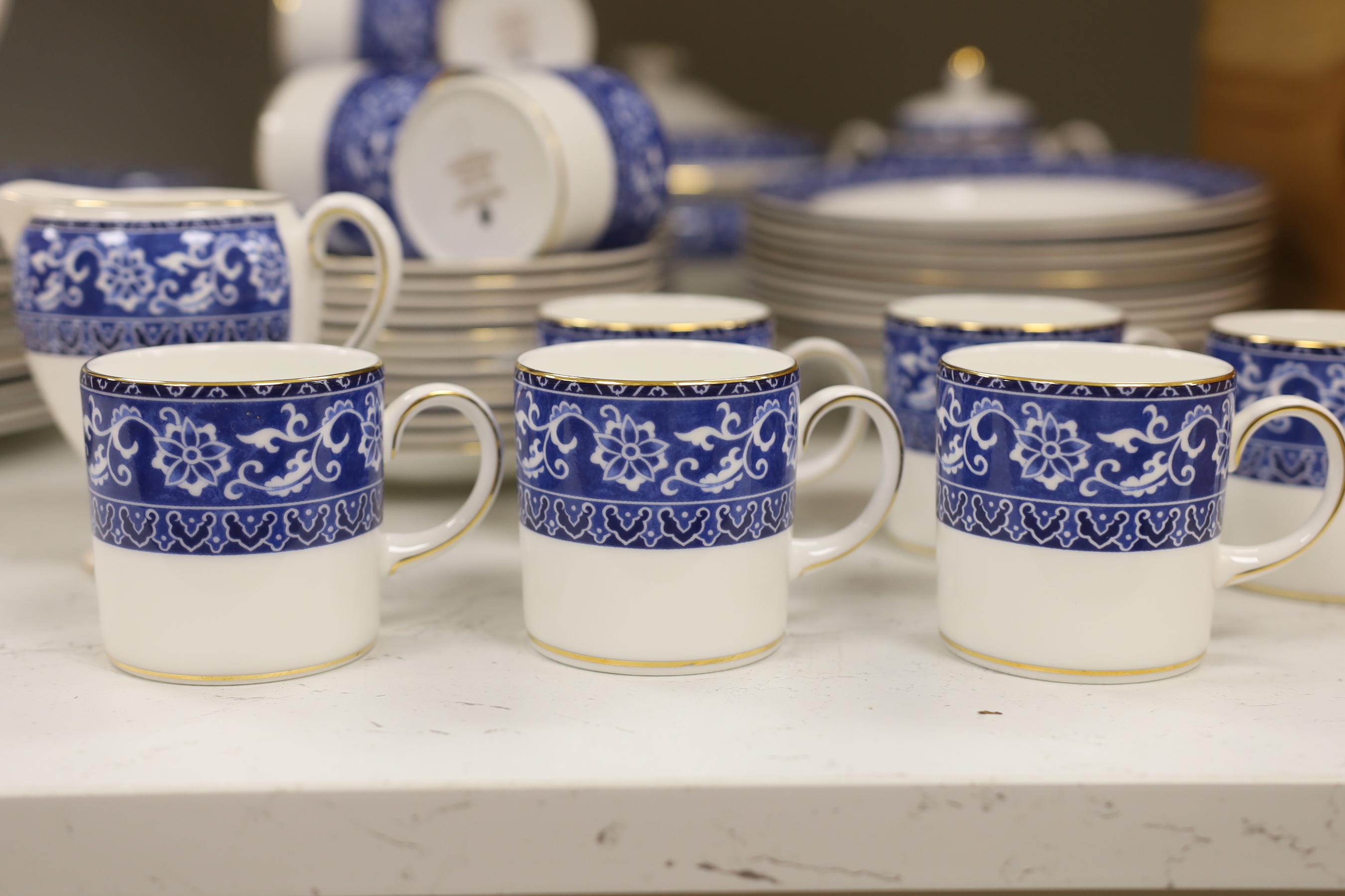 A Wedgwood Bokhara pattern 55 piece part dinner service, including a lidded vegetable tureen, a lidded sugar bowl, a cream jug, 12 dinner plates, 12 side plates, 12 dessert plates, 11 soup bowls, 3 pudding bowls and 2 ov